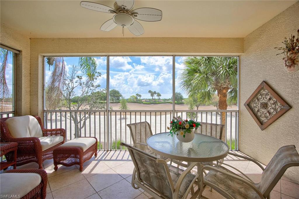 Screened lanai featuring textured wall finishes, a ceiling fan, and tiled flooring
