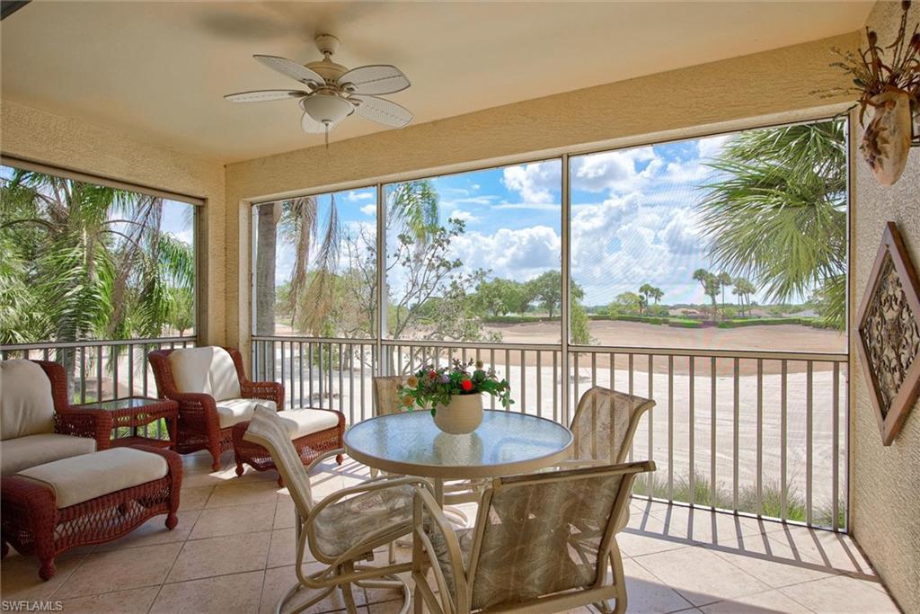 Screened lanai featuring tile flooring, a ceiling fan, and extensive views of the outdoor landscape