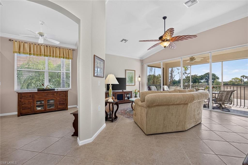 Spacious interior featuring tile flooring and a vaulted ceiling