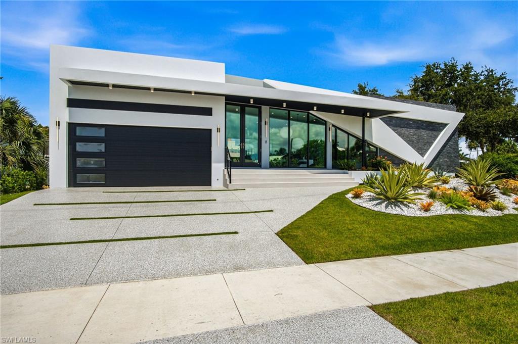 Contemporary facade featuring a dark gray garage door with frosted window inserts