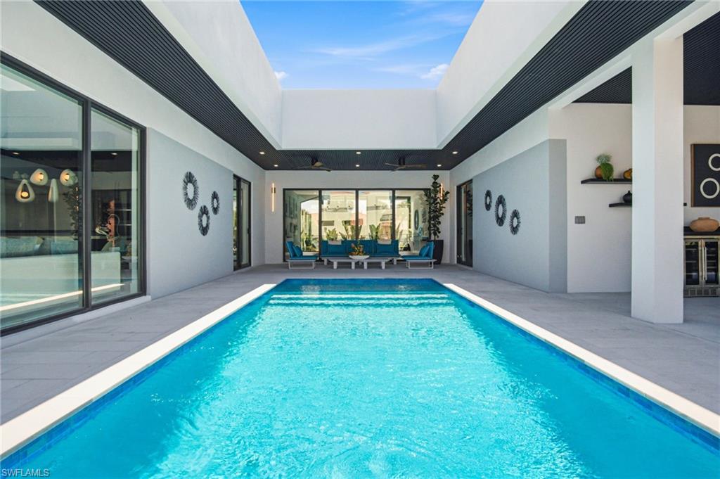 Courtyard pool featuring a rectangular design, light tile coping, and surrounding patio