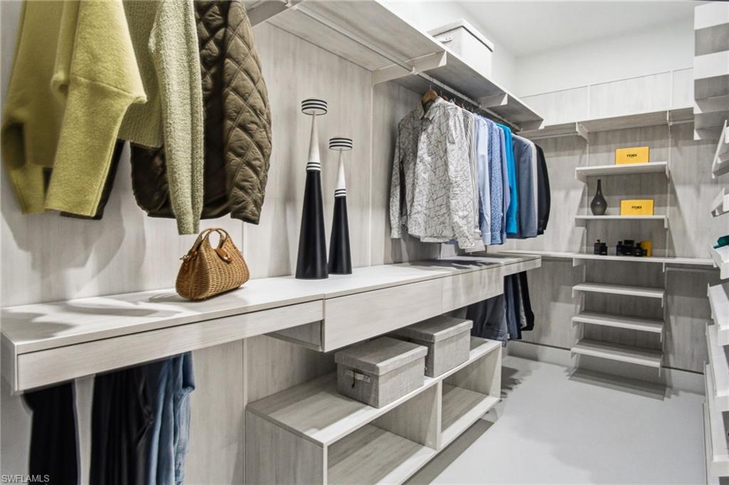 Custom closet system featuring light wood-finish cabinetry