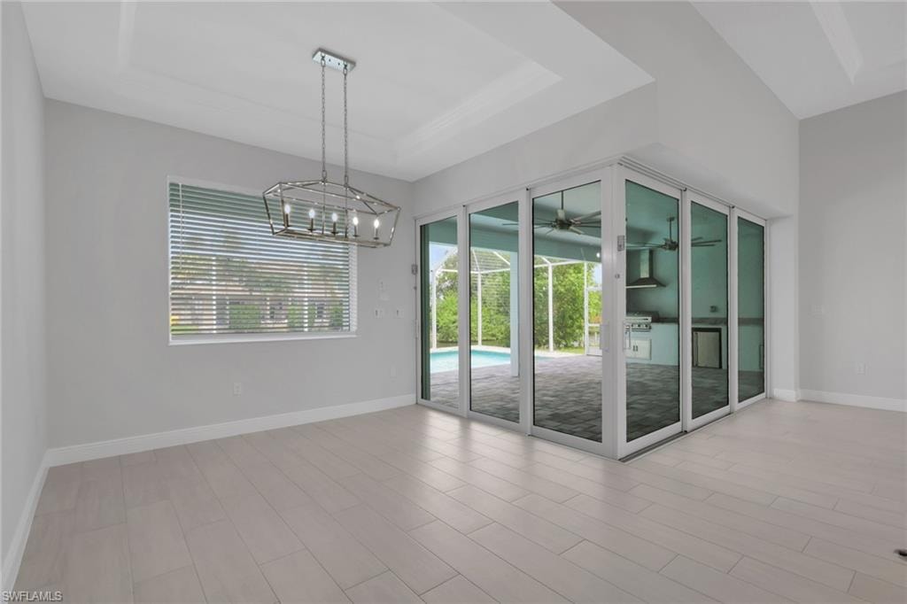 Dining area and 90 degree sliding glass doors to the pool/lanai area