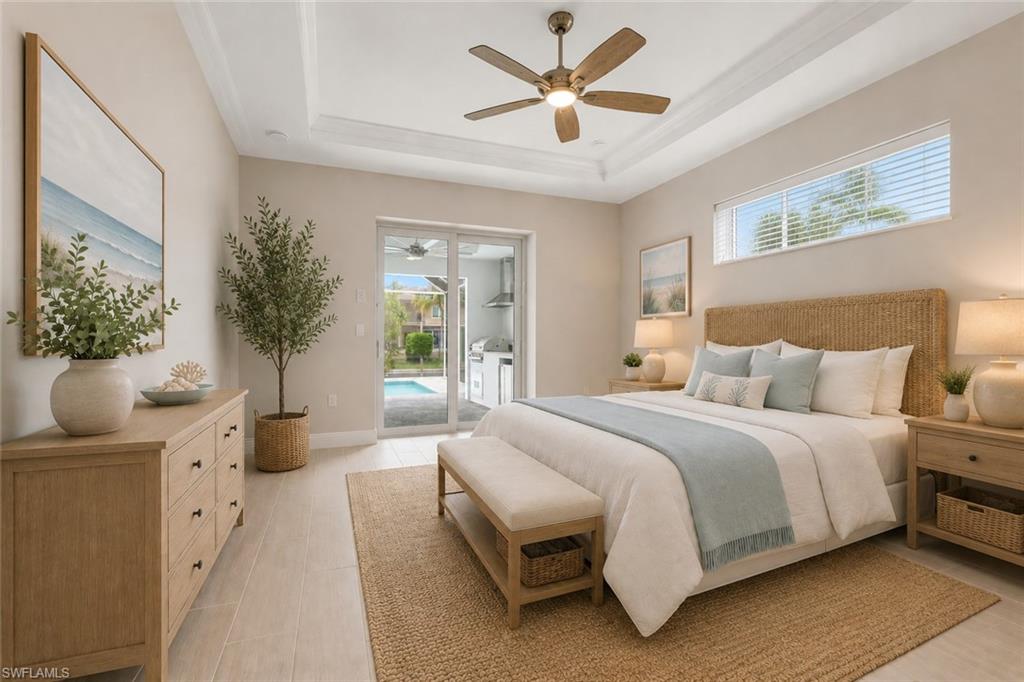 Owner's bedroom with tray ceiling, transom window for natural light, pool/lanai access through sliding glass doors, virtually staged.