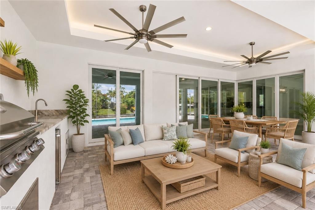 15' deep by 38' long under truss lanai with summer kitchen. Virtual staged