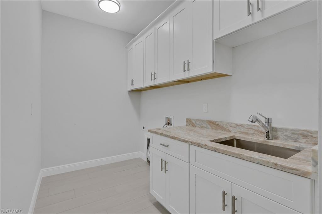 full sized laundry with utility sink and extra storage