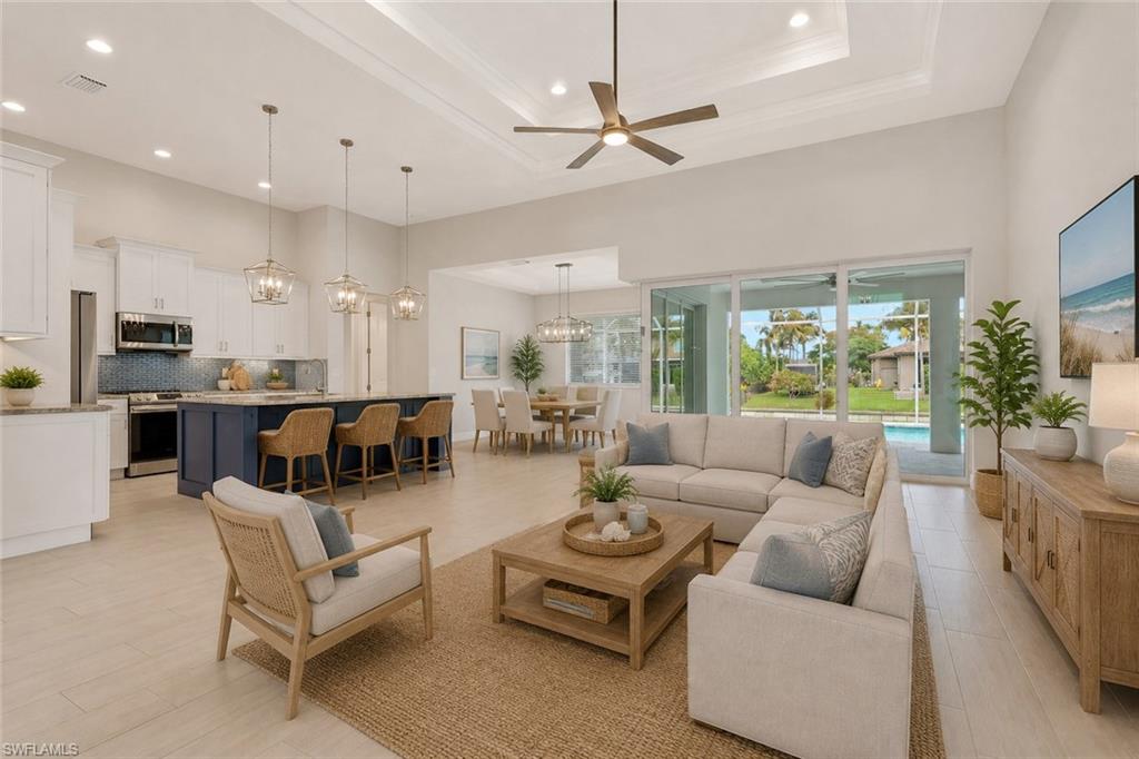 Virtually staged great room with tray ceilings and custom open kitchen.