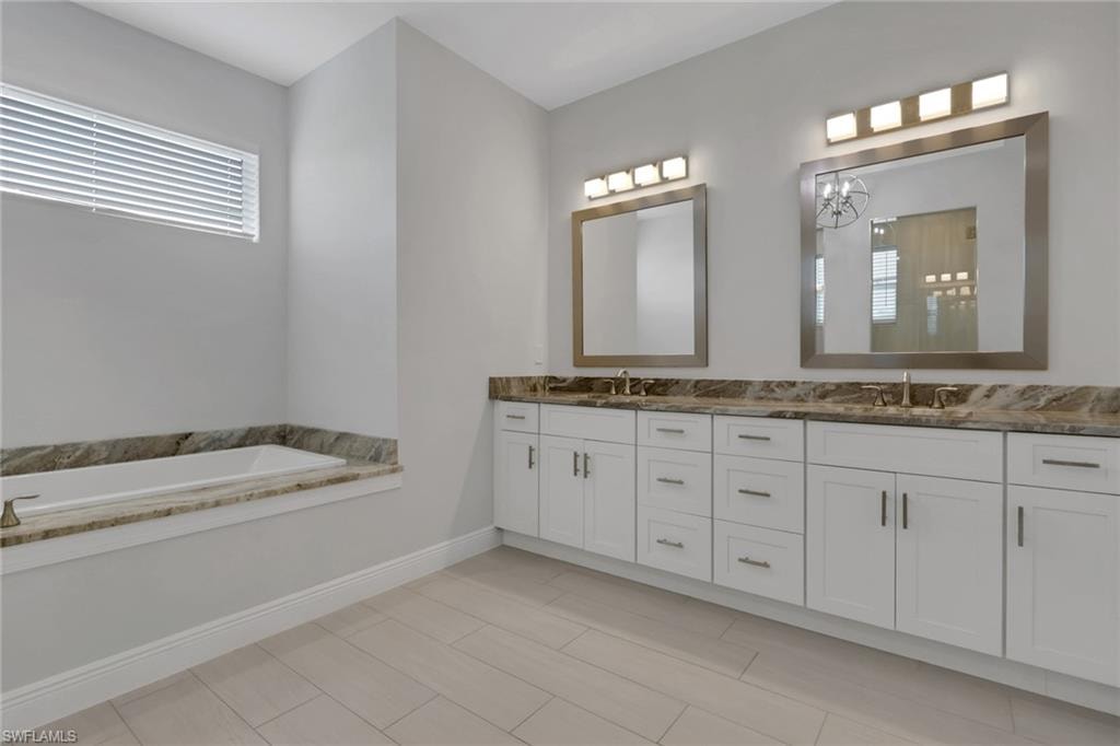 Owner's bath with dual vanities, matching granite counters, soaking tub and walk in shower