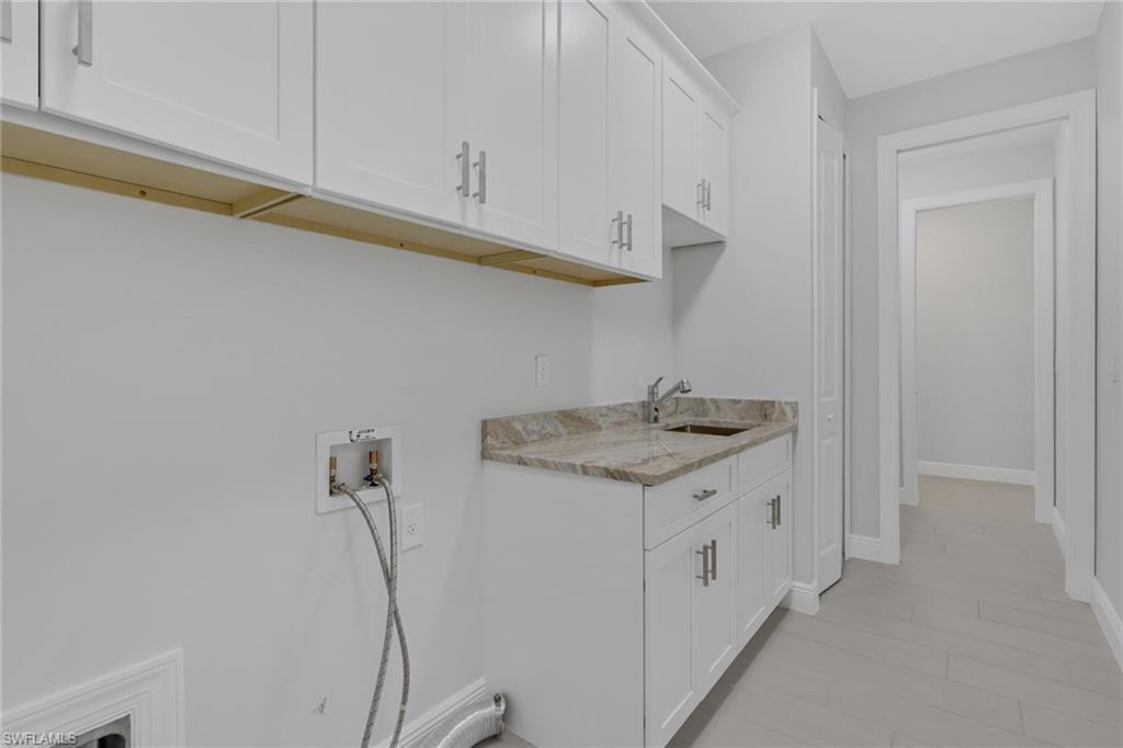 full sized laundry with utility sink and extra storage