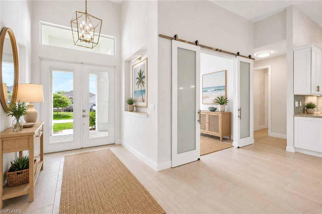 Entry and office/den with glass bar doors, Virtually staged