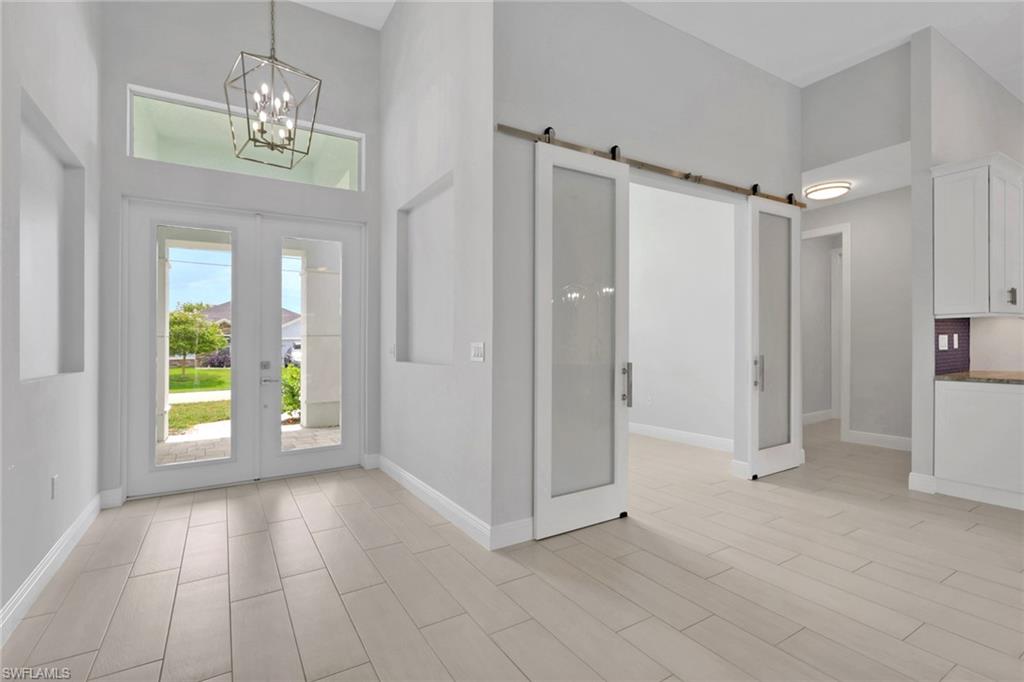 Entry and office/den with glass bar doors