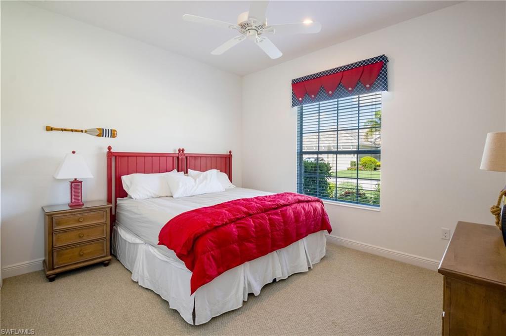 Carpeted bedroom with a window featuring horizontal blinds and a decorative valance