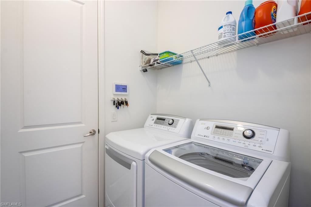 Dedicated laundry area featuring a top-loading washer and front-loading dryer