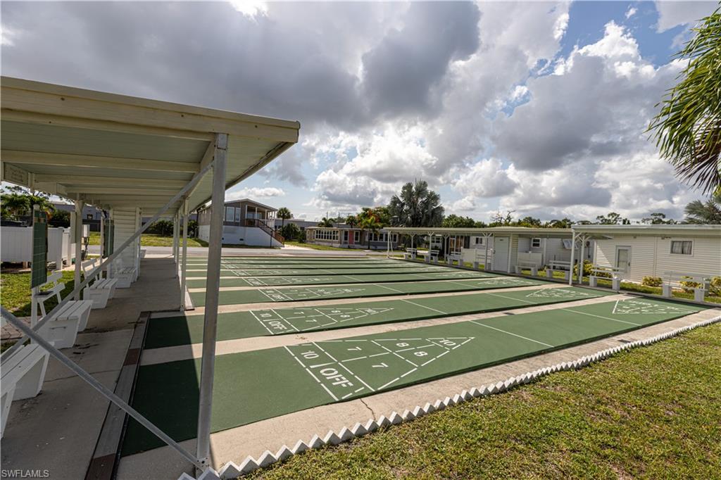 Multiple shuffleboard courts featuring green surfacing and white markings