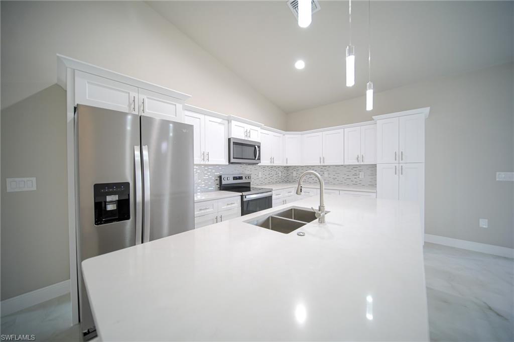 The Island Kitchen Comes With Quartz Countertops, Real Wood Flat Panel Cabinets & Drawers, A Floor To Ceiling Pantry, Brand New Stainless Steel Appliances, And A Tile Backsplash!