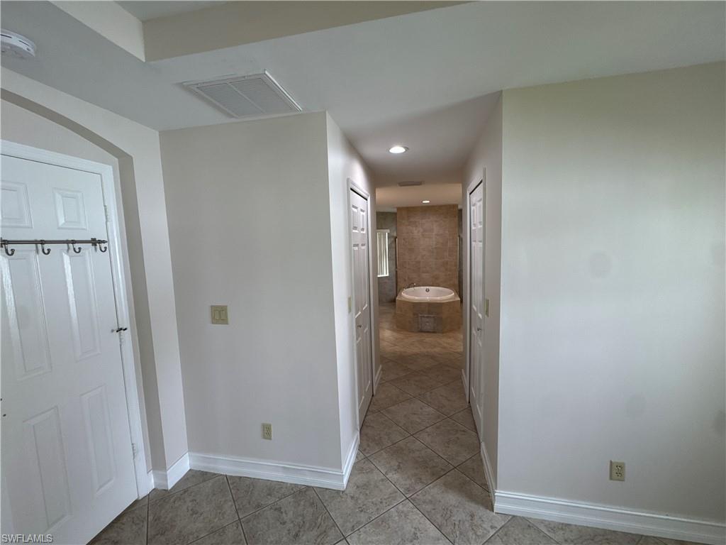 Primary bedroom hallway with two walk in closets