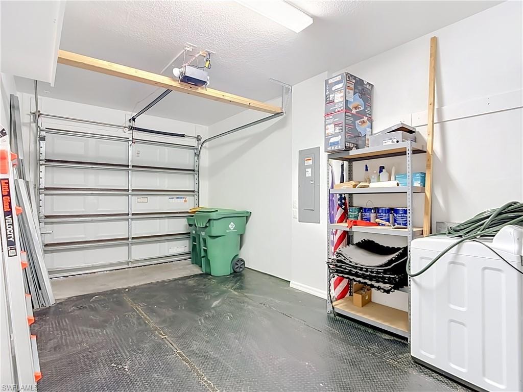 Single-car garage featuring a textured floor, white walls, and an overhead garage door opener