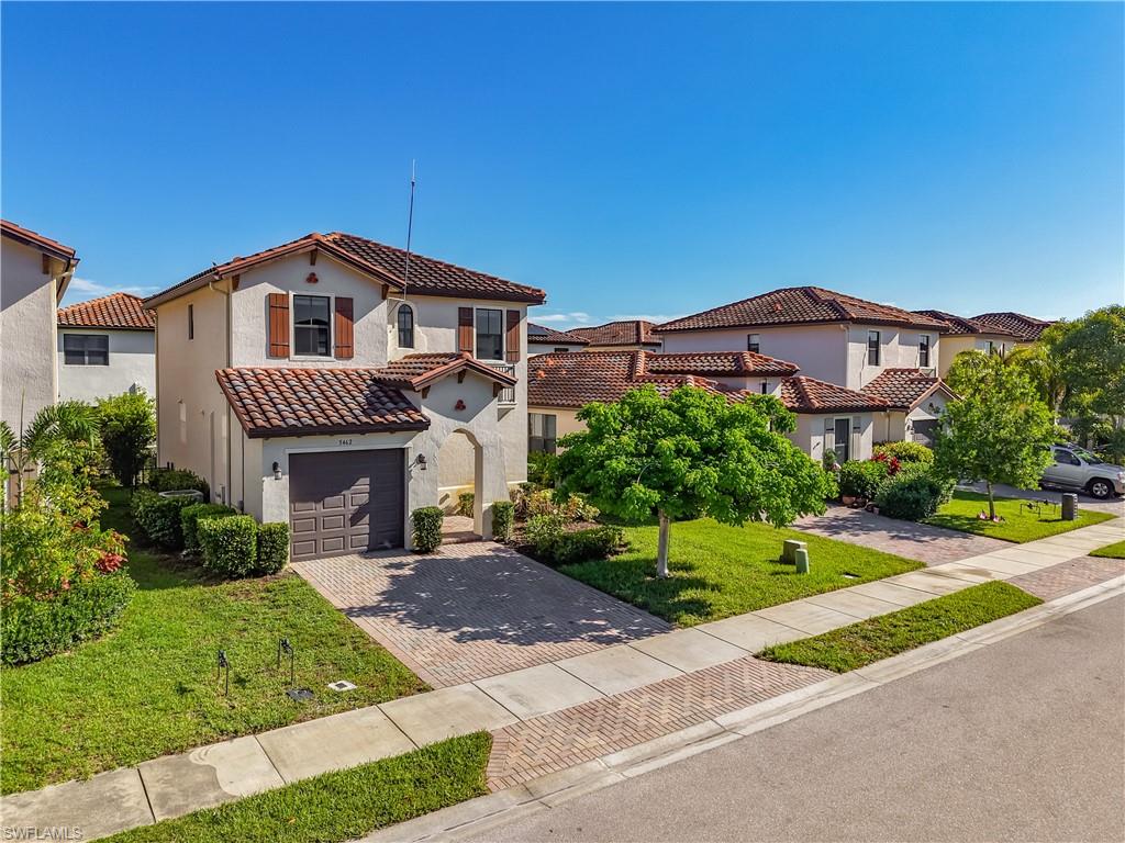 Mediterranean-style residence featuring a tile roof and stucco exterior