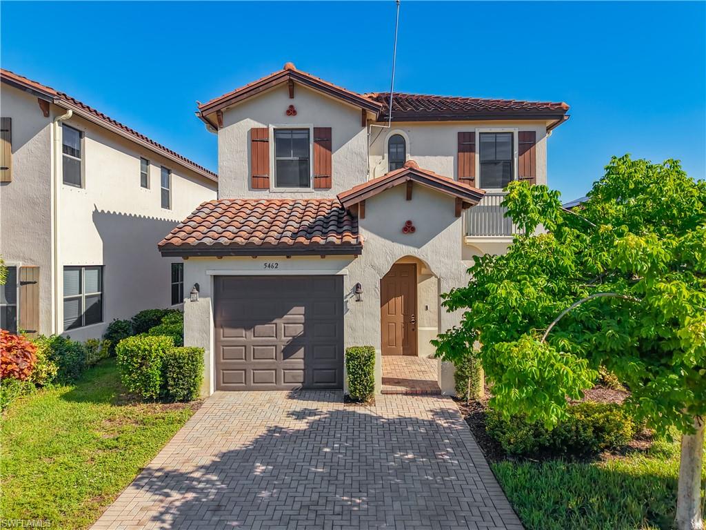 Two-story stucco exterior with a terra cotta tile roof