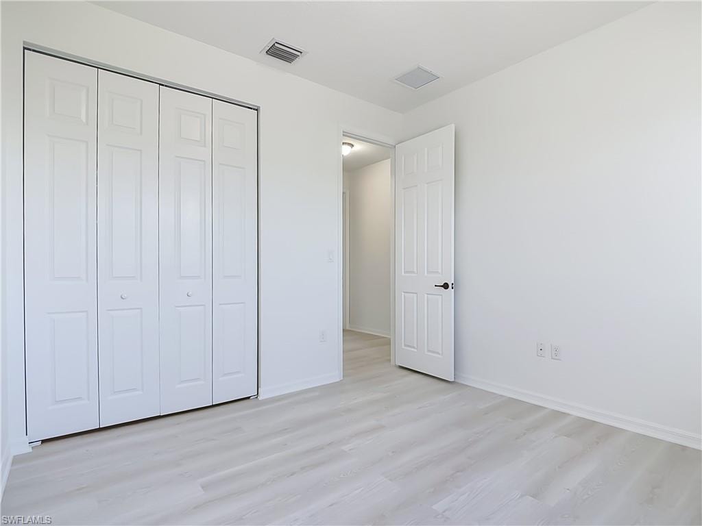 Light wood-finish flooring complements white walls