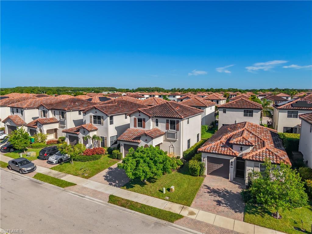 Residential community featuring uniform Mediterranean-style architecture with barrel tile roofs and stucco exteriors