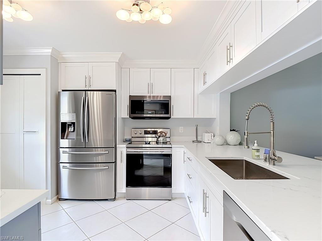 Kitchen featuring white shaker cabinetry, stainless steel appliances, white countertops, and a stainless steel sink with a high-arc faucet