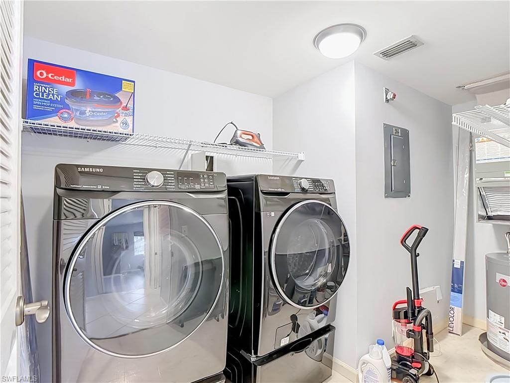 Dedicated laundry area featuring modern front-load washer and dryer units