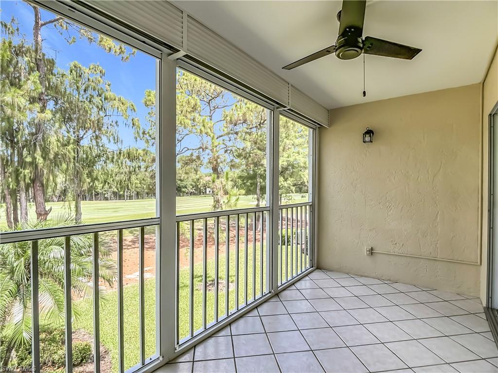 Screened porch featuring tiled flooring and a ceiling fan