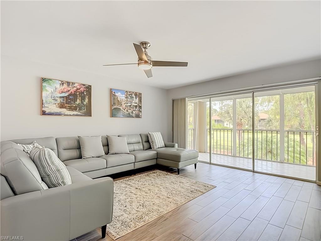 Living area with plank-style flooring and a ceiling fan