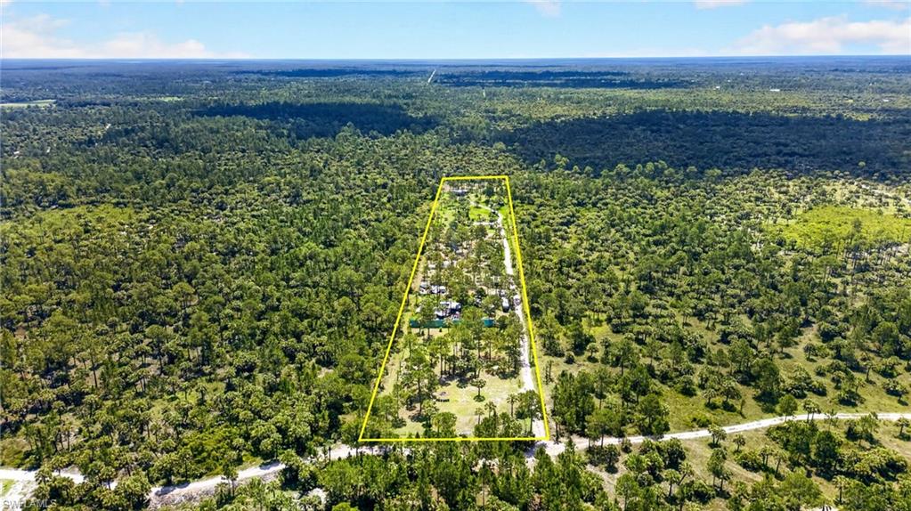Expansive parcel of land bordered by mature trees and natural vegetation