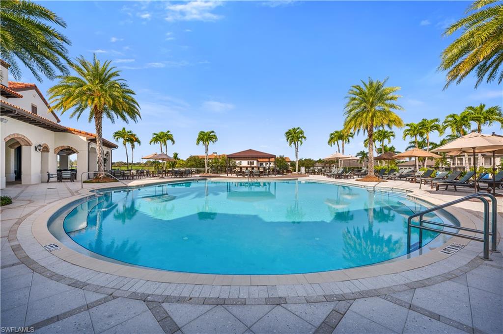 Inviting outdoor swimming pool featuring a curved design and integrated steps