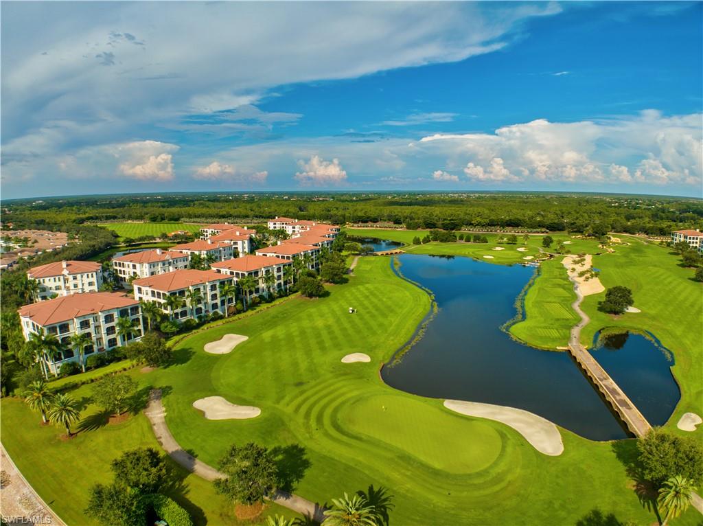 Aerial perspective showcasing residences bordering a golf course with multiple greens and sand traps