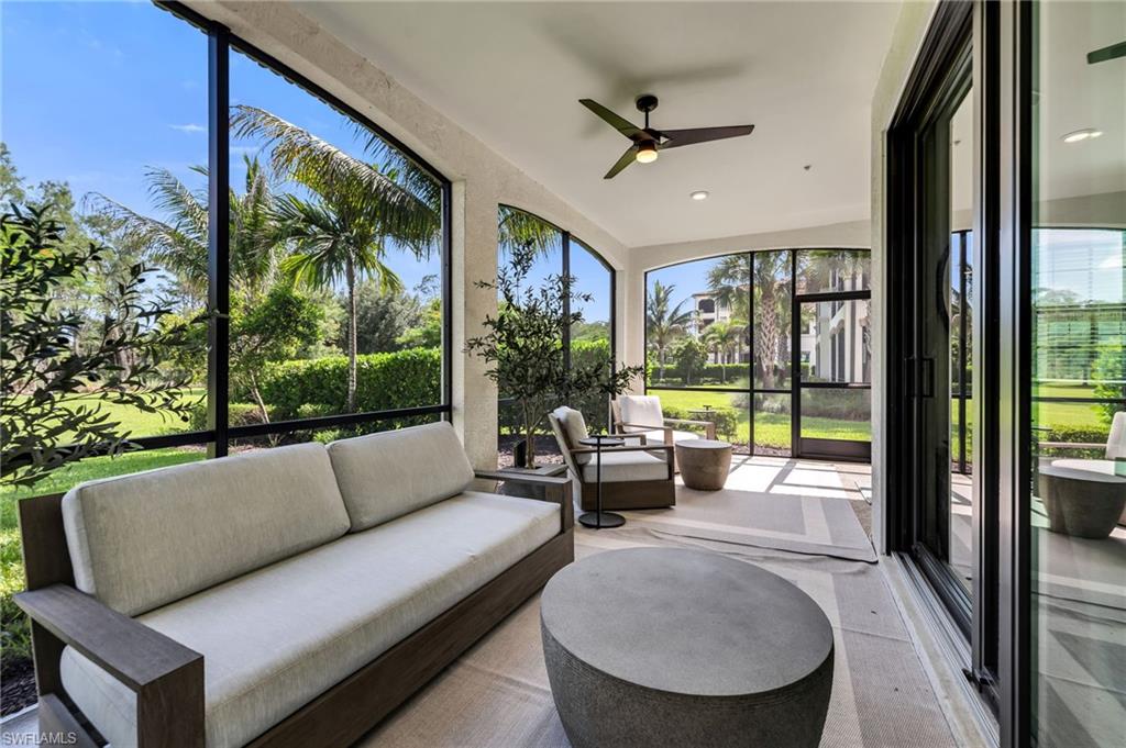 Screened lanai featuring large arched openings, a ceiling fan, and sliding glass door access