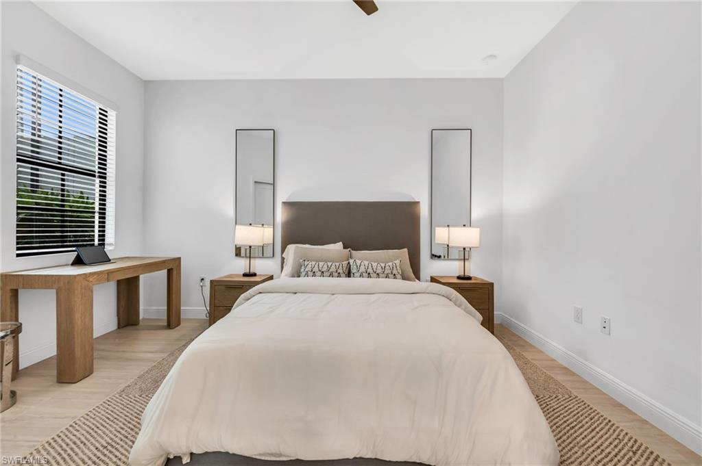 Bright room featuring wood-finish flooring and a ceiling fan