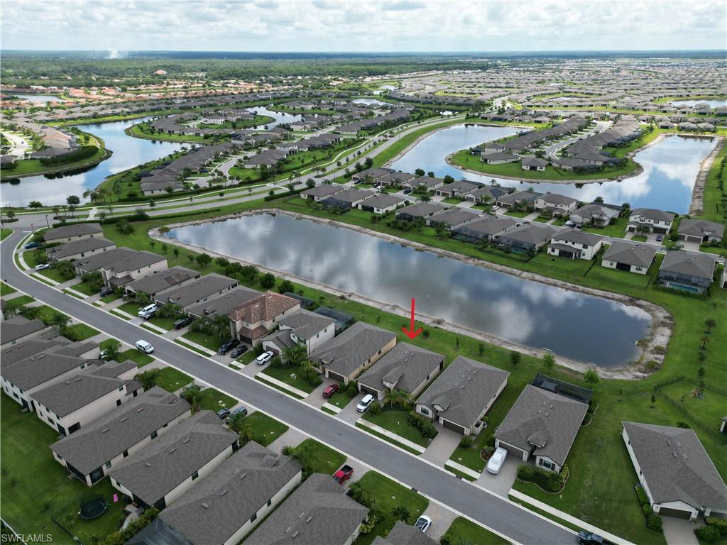 Aerial perspective highlighting a residential community with water features