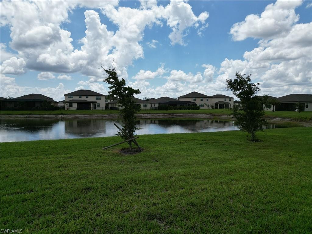 Expansive green lawn bordering a tranquil pond