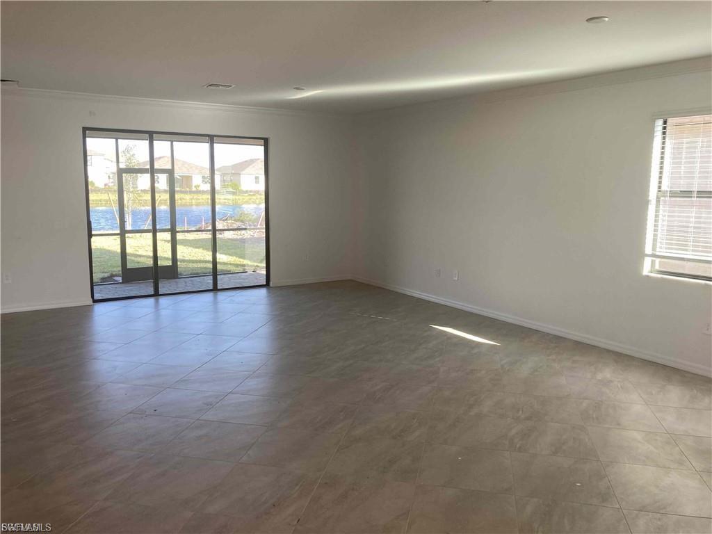 Expansive room featuring large format tile flooring, neutral wall tones, and recessed lighting