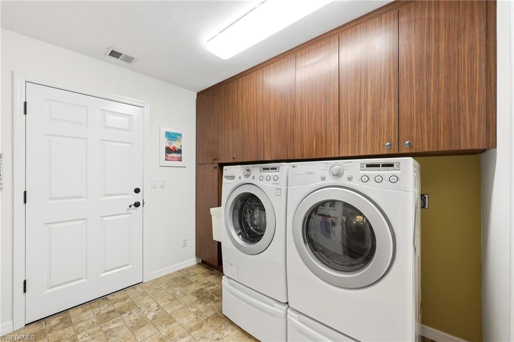 Laundry room with built-in cabinetry, utility sink, and direct garage access for everyday convenience