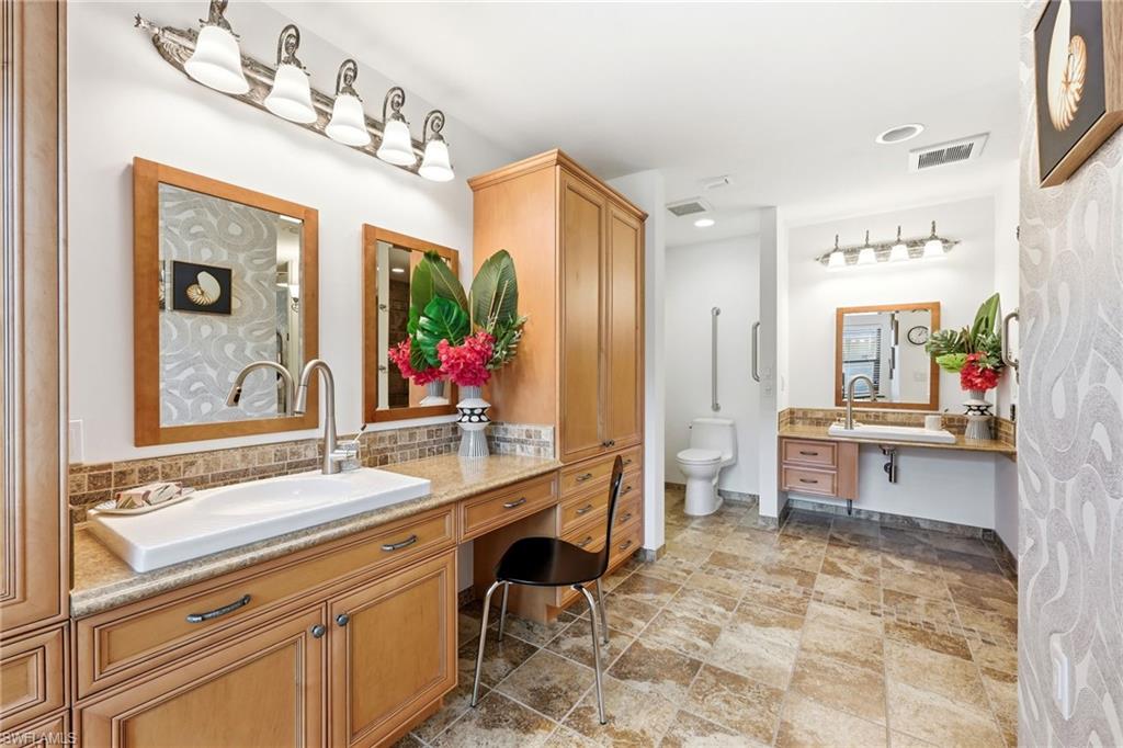 Primary bathroom with dual sinks, extended vanity, and spacious layout designed for ease of movement and everyday functionality