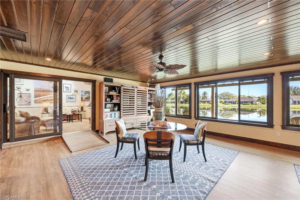 Enclosed sunroom with panoramic lake views and impact windows, designed for year-round living and everyday comfort