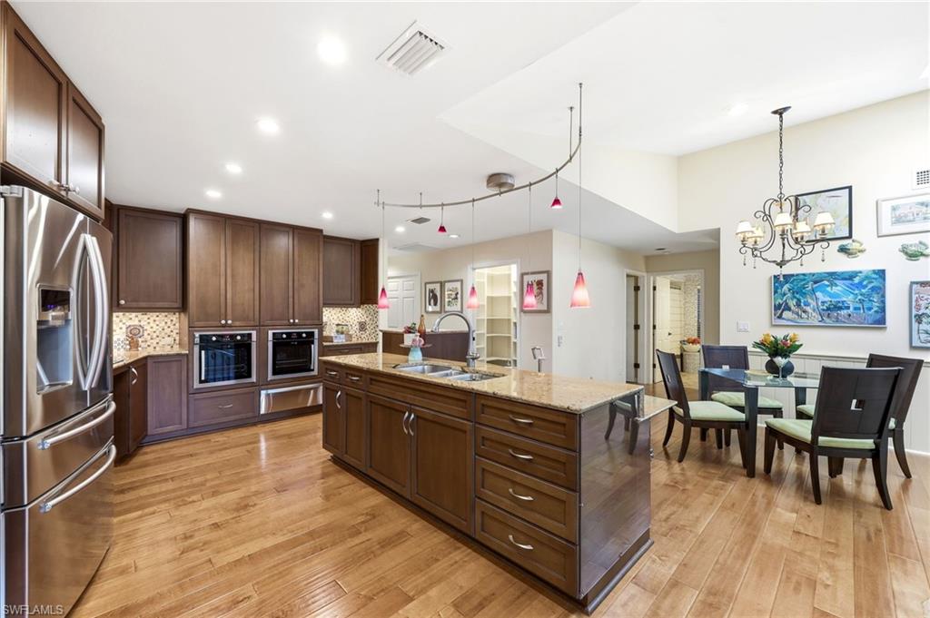 Accessible kitchen with large island, easy-access storage, and open layout designed for aging in place and mobility-friendly living