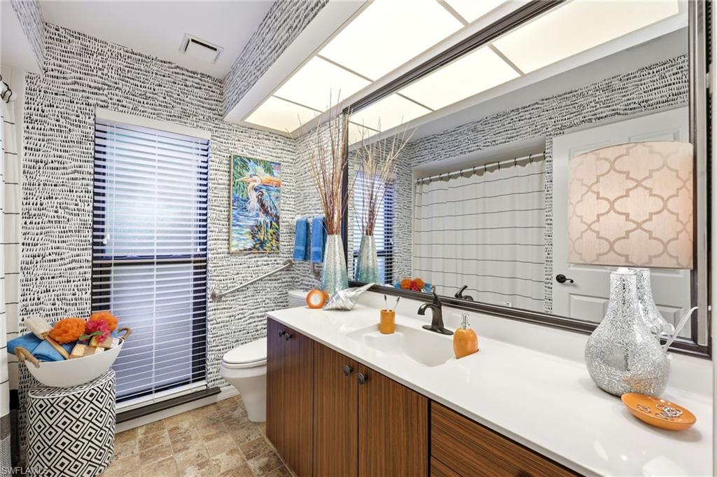 Full bathroom with walk-in shower, wide layout, and design supporting ease of movement and long-term living