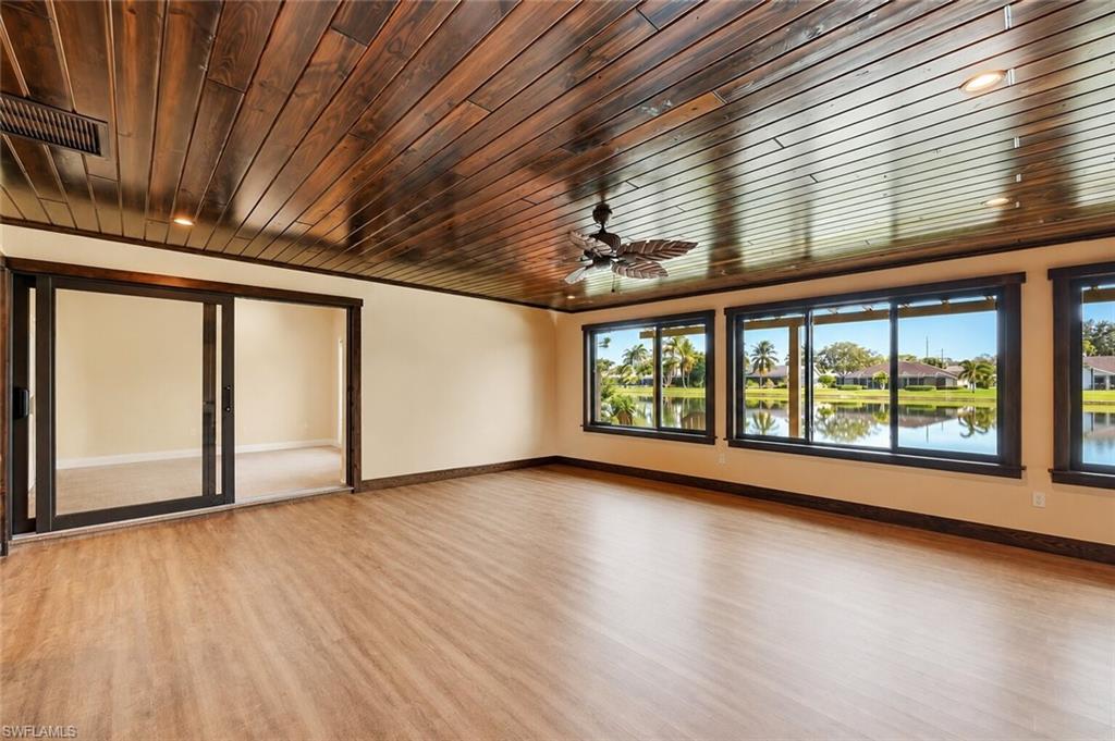 Sun room with panoramic views of the lake. (ai generated to remove furniture)
