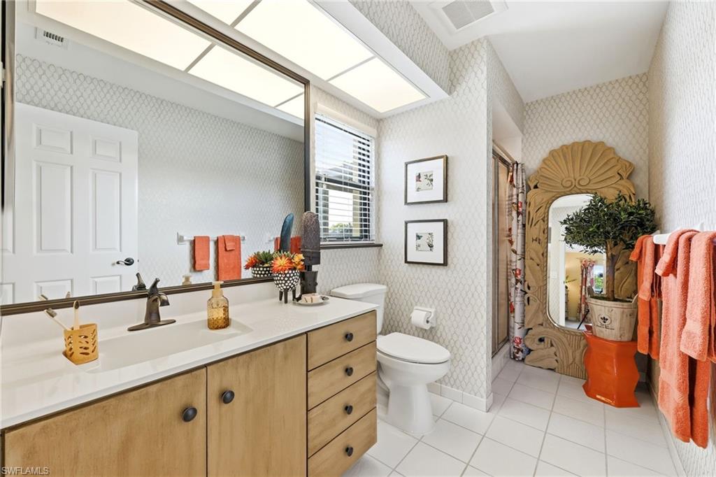 Guest bathroom with walk-in shower and extended vanity, offering a clean and functional layout for everyday use