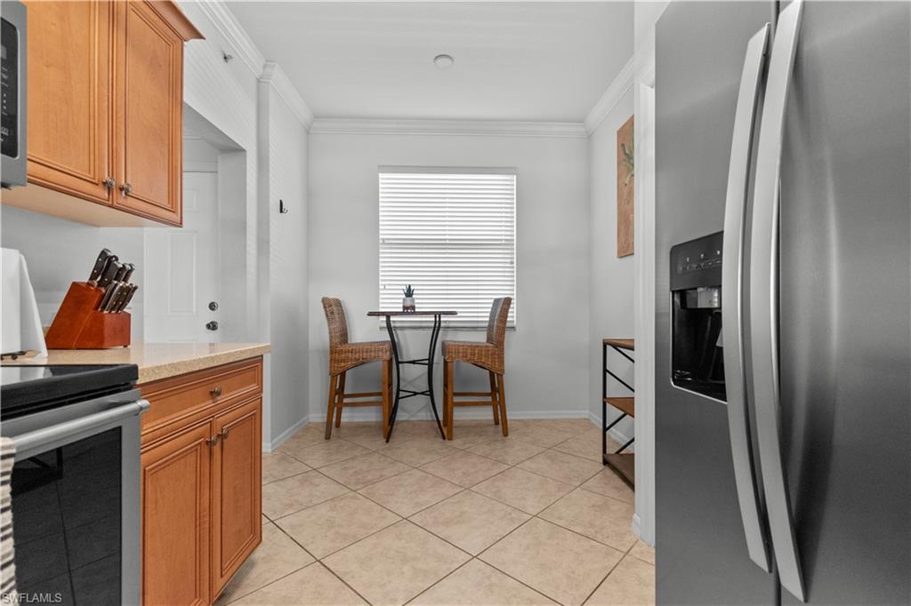 Kitchen area featuring Maple cabinetry,Corian countertops, and newer stainless steel appliances