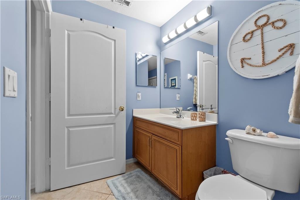 Gues bathroom featuring Maple cabinetry and updated light fixtures