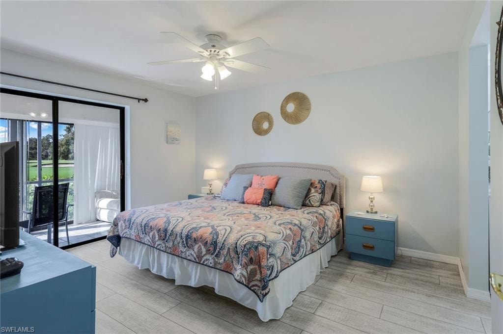 Bedroom featuring wood-finish flooring, a ceiling fan with integrated lighting, and direct access to an outdoor balcony through sliding glass doors