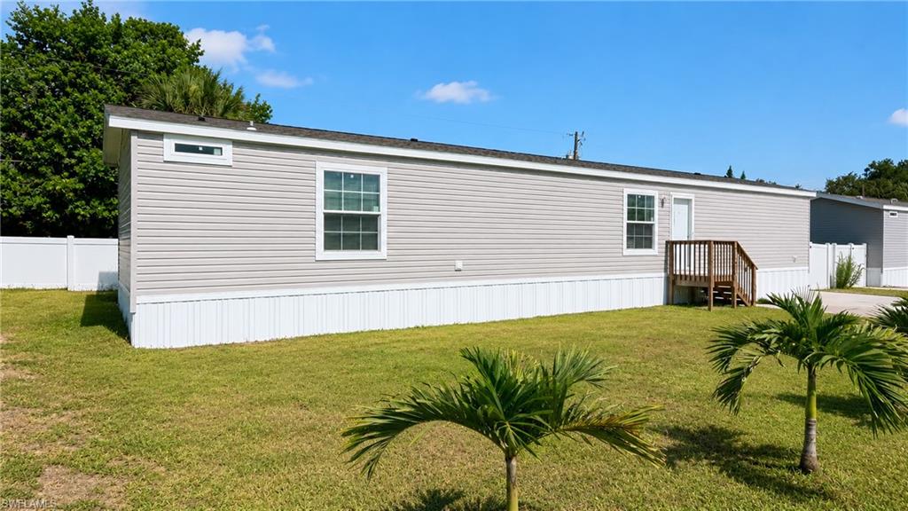 Light gray siding exterior with white trim and white vinyl skirting