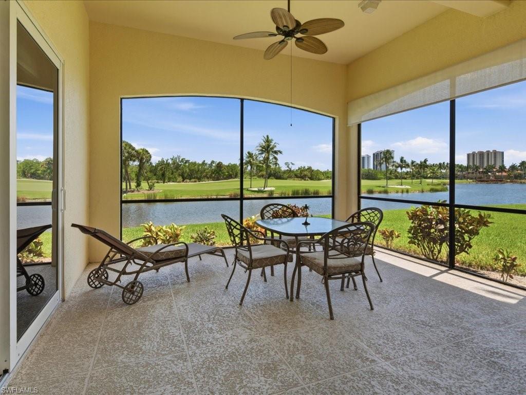 Screened lanai featuring textured tile flooring and a ceiling fan