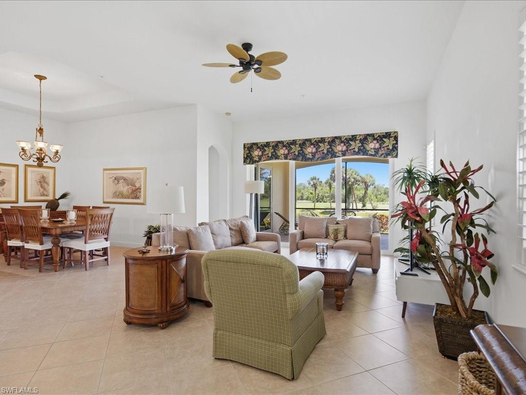 Expansive living area with large format tile flooring and high ceilings